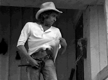 [Dylan zips his fly in a film still from Hearts of Fire]